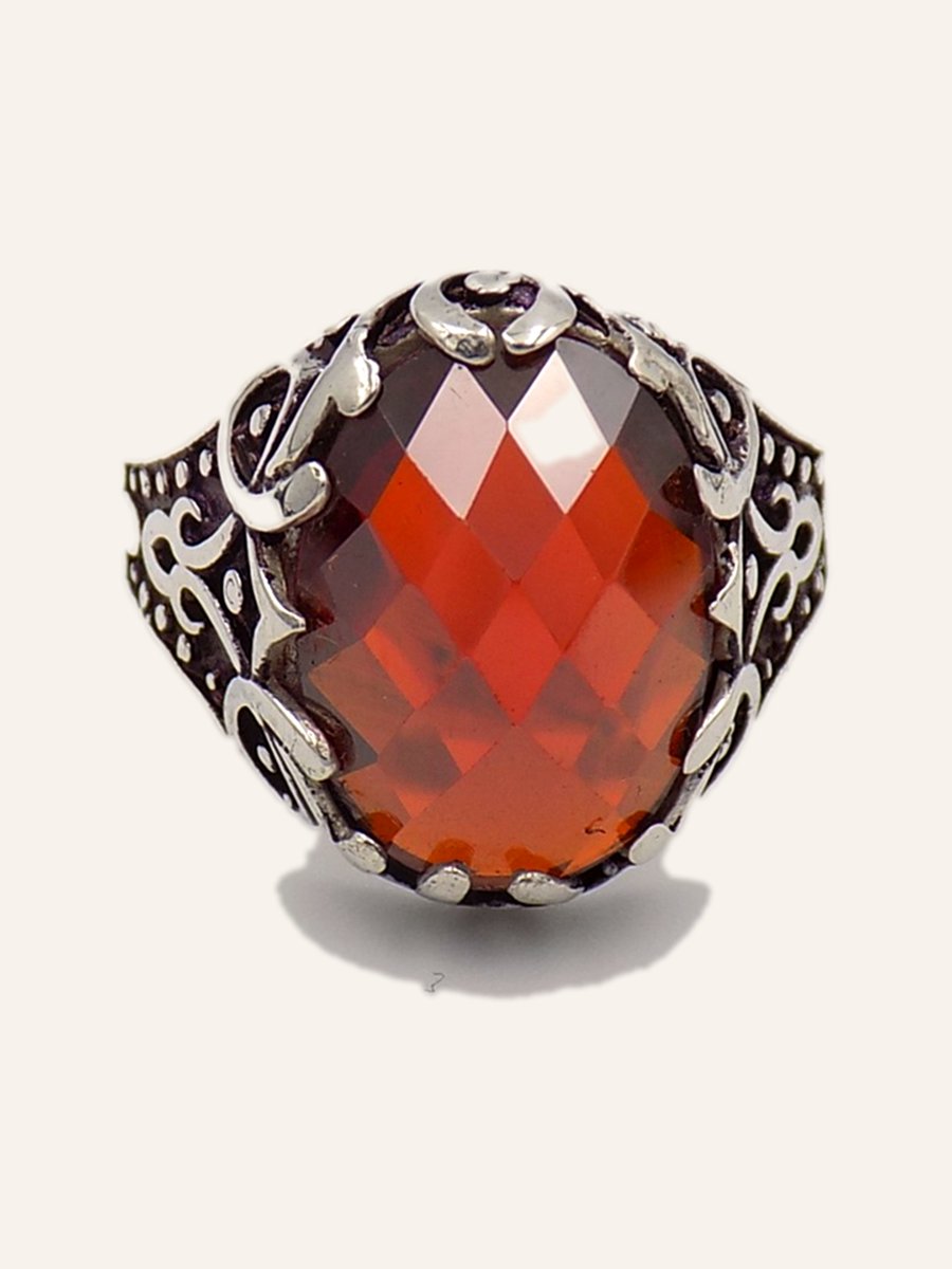 Ring with red cubic zirconia and chased scrolls