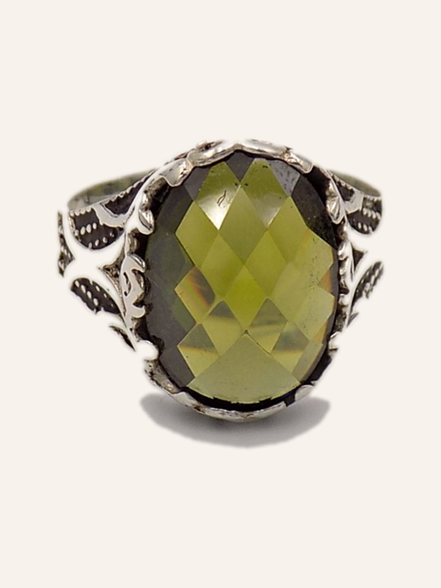 Ring with olive green cubic zirconia on an openwork setting