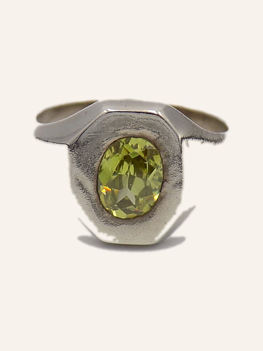 Ring with green cubic zirconia on a plain setting