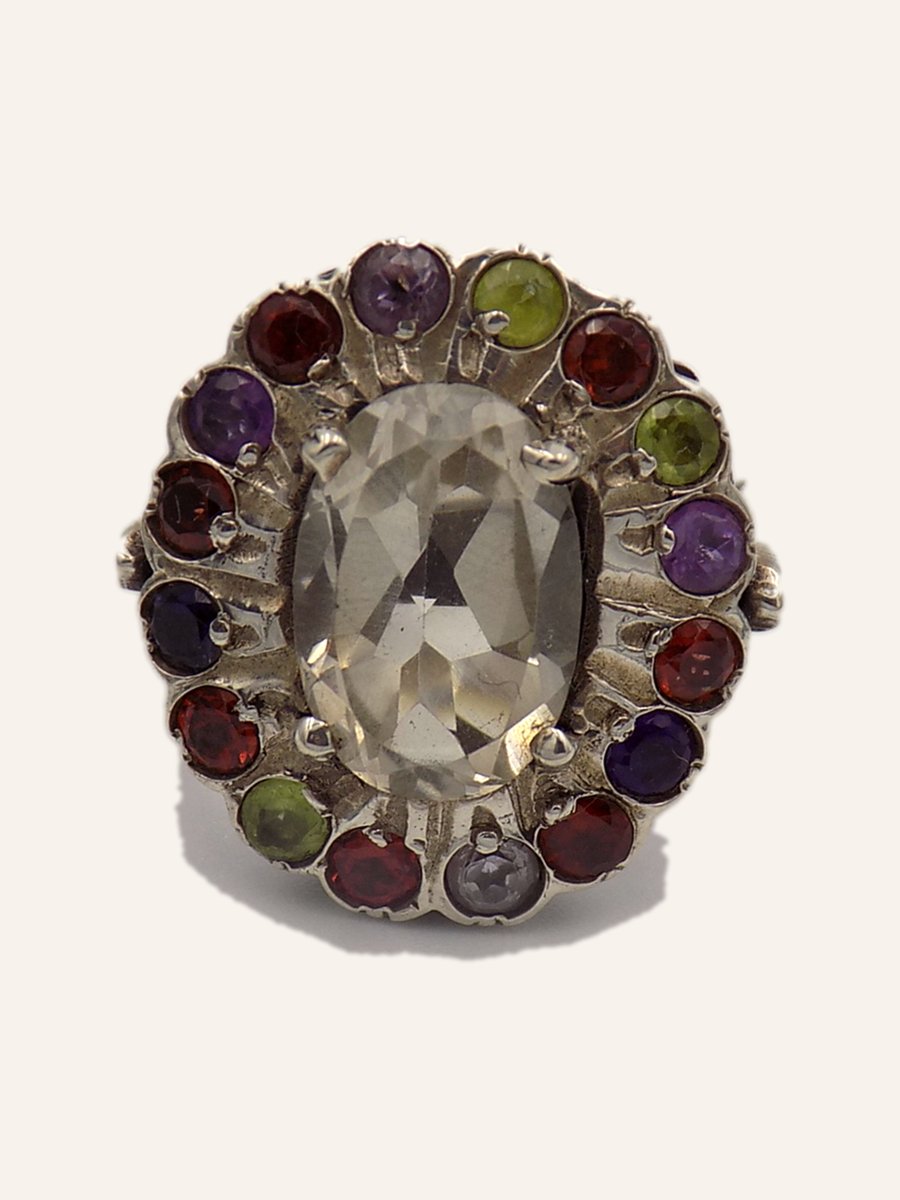 Ring with pale stone and multicoloured halo