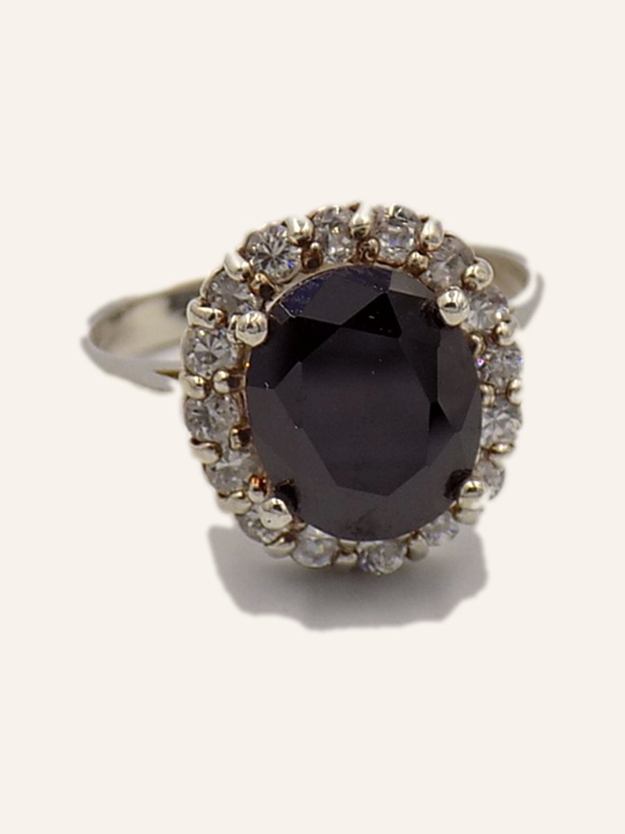 Ring with oval onyx and pale halo