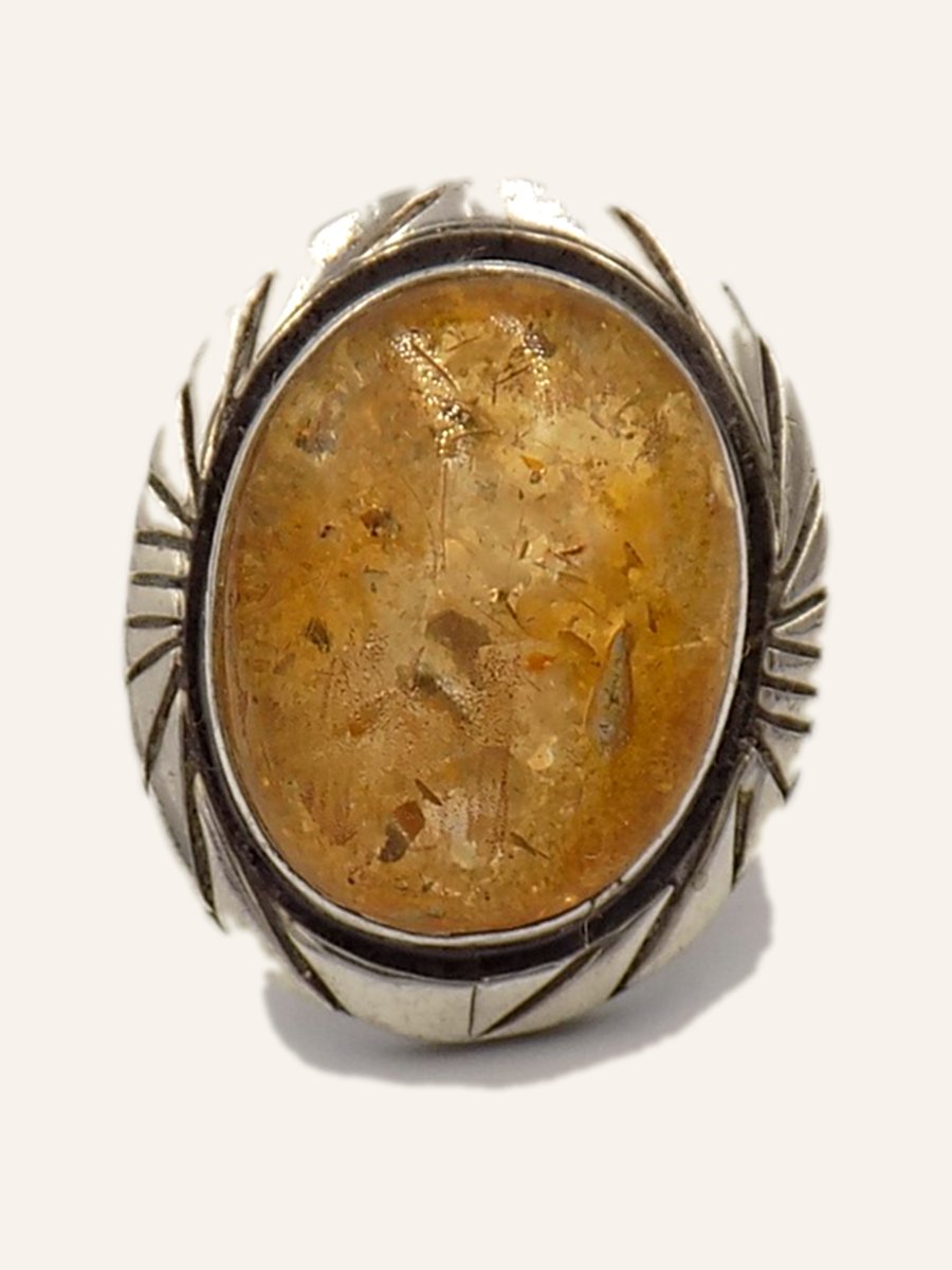 Ring with large amber and chased frame