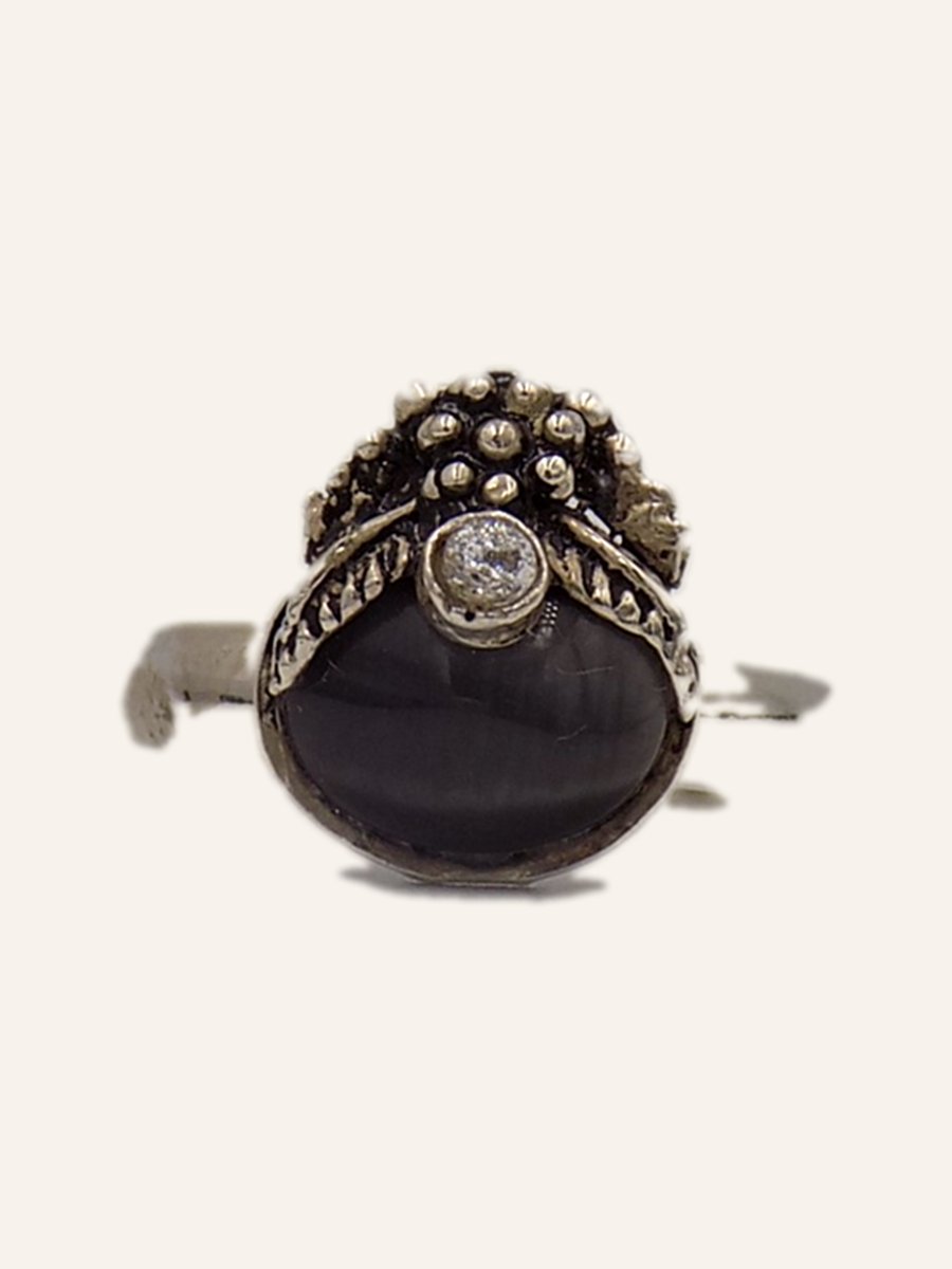 Ring with domed onyx and beaded crown