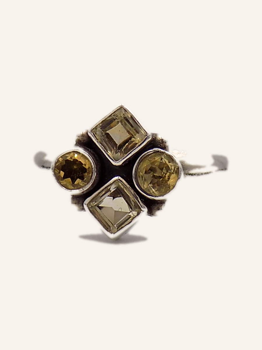 Ring with four yellow stones in a square