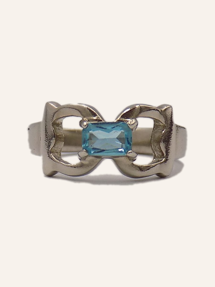 Ring with blue topaz and silver loops