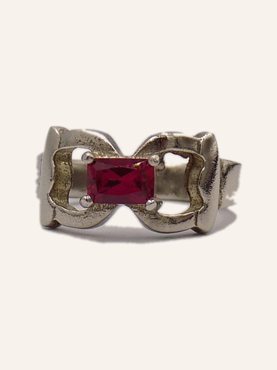 Ring with red stone and openwork loops