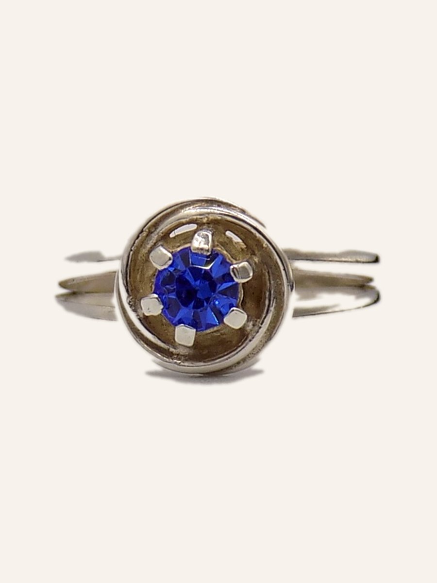Ring with blue cubic zirconia on a silver circle