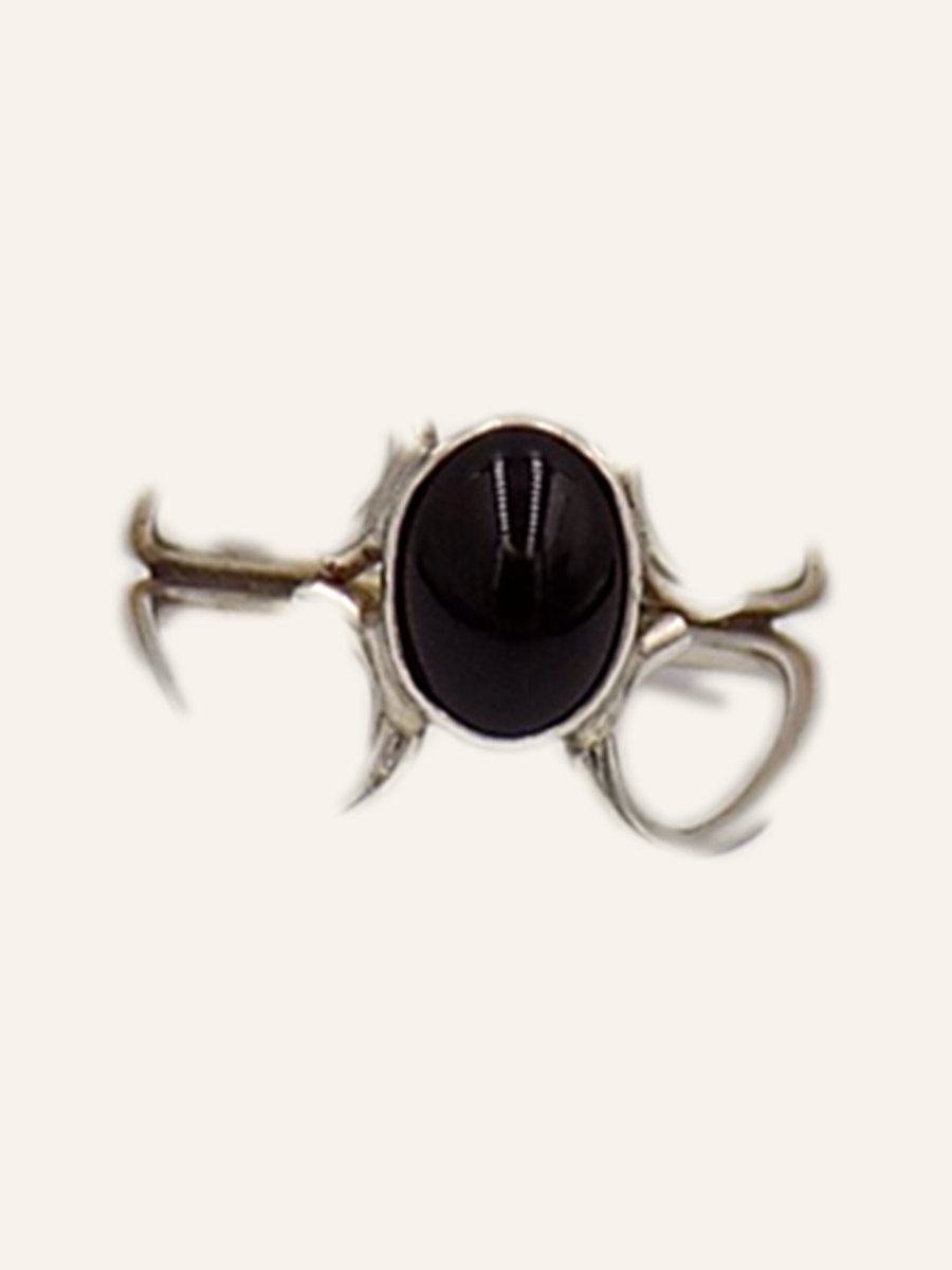 Ring with domed onyx and broad claws