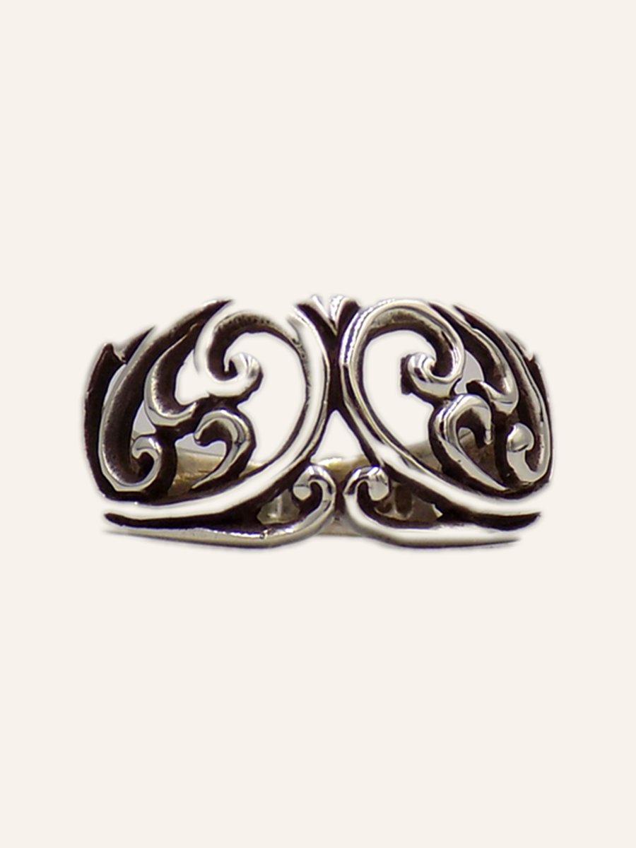Openwork ring with facing scrolls